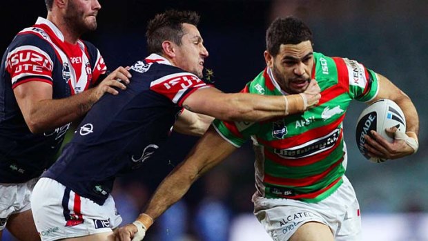 Hands off: Greg Inglis evades the Sydney Roosters.