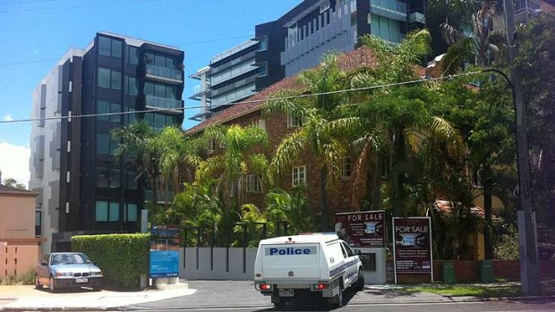 Police outside Hohepa Morehu-Barlow's apartment building, at rear.