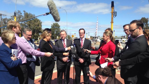 Anthony Albanese and Matt Keogh surrounded by the media scrum in Canning.