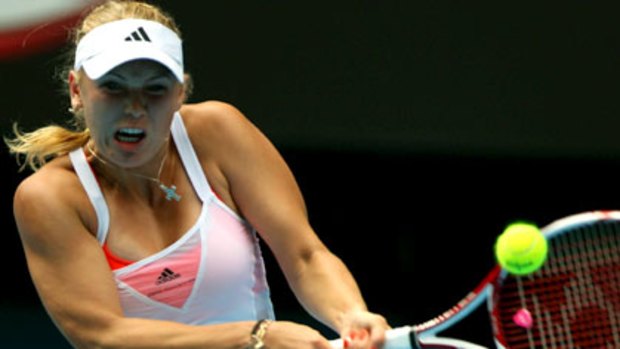 Caroline Wozniacki swings hard during her quarter final at the 2011 Australia Open.