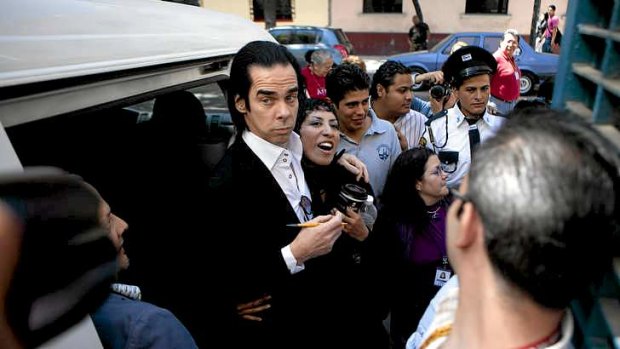 Nick Cave poses with a fans while promoting 'Push the Sky Away,' in Mexico City in February.
