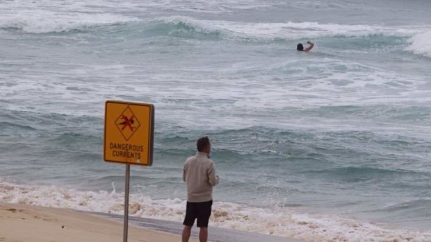 Subtle killer: A swimmer at Bondi swims near a rip tide despite lifeguard warning signs.
