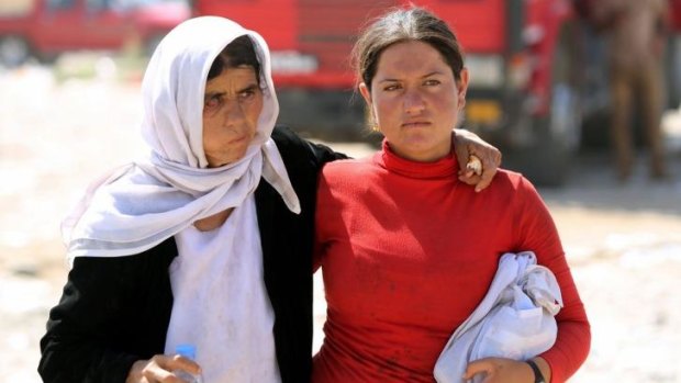 Targets for Islamic State ... Yazidi Iraqi women walk at the Bajid Kandala camp near the Tigris River, in Kurdistan's western Dohuk province, where they took refuge after fleeing advances by IS jihadists in Iraq.