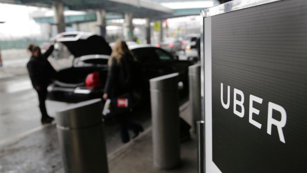 A sign marks a pick-up point for the Uber car service at LaGuardia Airport in New York. 