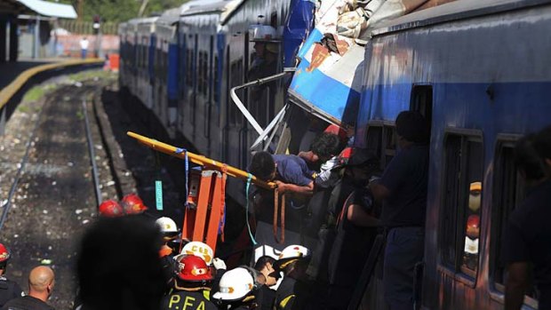 Crumbled wreckage ... Firemen rescue wounded passengers from the commuter train.