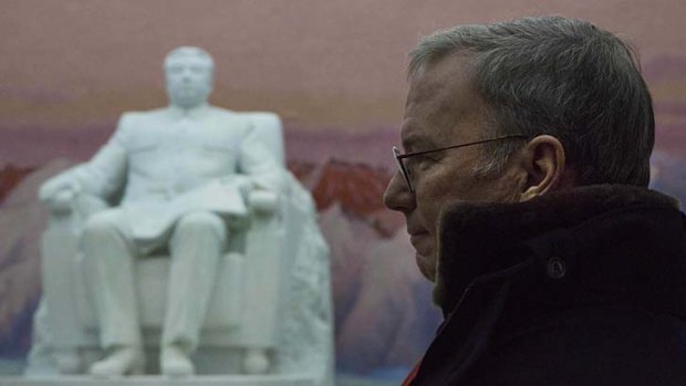 Eric Schmidt stands near a statue of the late North Korean leader Kim Il-sung.