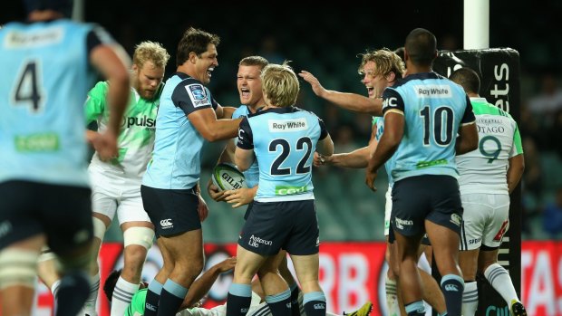 Try time: The Waratahs celebrate Tom Robertson's try against the Highlanders.