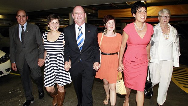 Campbell Newman arriving at the Hilton Hotel with his family.