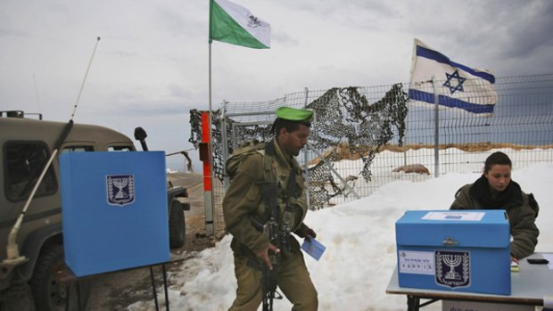 Walkover...an Israeli soldier cast a prepoll vote at a military outpost in the Golan Heights on Monday.