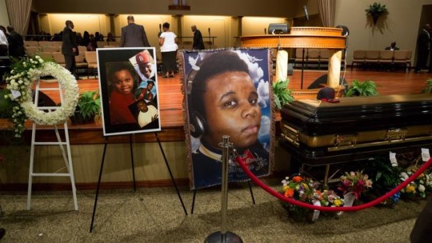 Photos surround the casket of Michael Brown before the start of his funeral at Friendly Temple Missionary Baptist Church in St Louis on August 25.