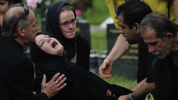 Overwhelmed ... Fatema, whose brother was being buried yesterday.