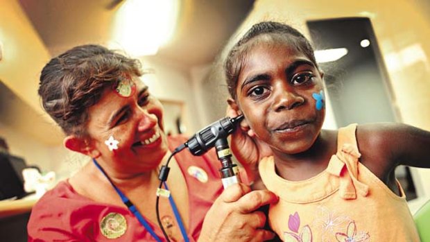 This won't hurt a bit ... Sandy Nelson checks the ear of Kirsty Dumoo during the opening of the Wadeye Health Centre.
