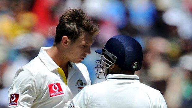 Australia's James Pattinson and Indian batsman Virender Sehwag exchange words.