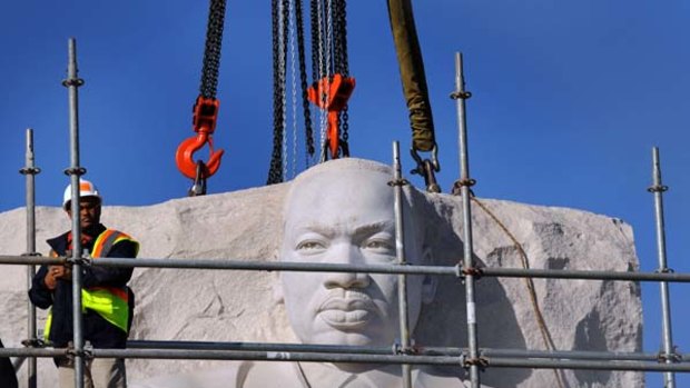"Stone of hope" ... the sculpted head of Martin Luther King being lifted into place on top of a piece of granite. King was assassinated in 1968.