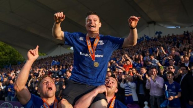 Brian O'Driscoll of Leinster celebrates at the end of the last match of his career, carried by Ian Madigan and Cian Healy.
