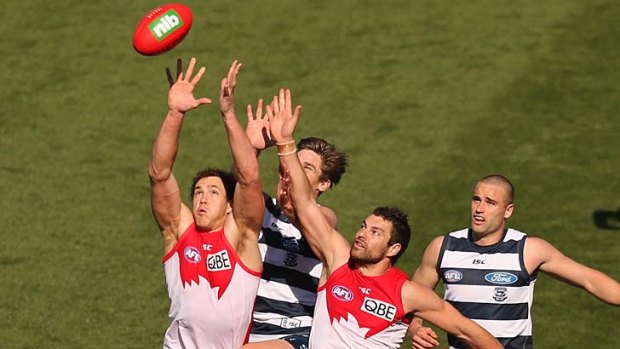 Up for it ... Tom Hawkins competes with Shane Mumford during yesterday's clash in Geelong. The Cats ran out comfortable winners in the end.