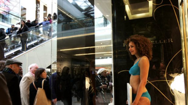 A model stands in a store window for the opening of Westfield London.