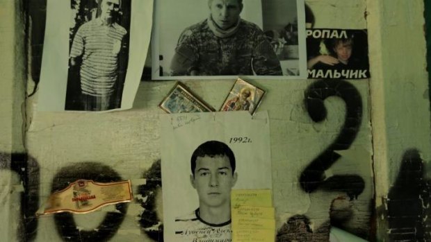 The faces of either dead or missing people are pinned to a wall at a checkpoint on the outskirts of Slaviansk.
