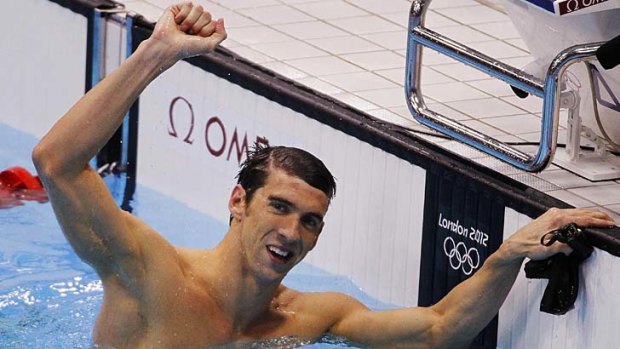 Another gold ... Michael Phelps has won the men's 100m butterfly for the third straight Olympics.