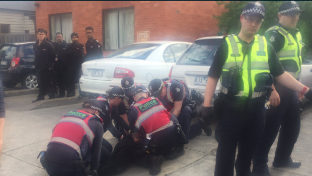 Police arrest a squatter in Bendigo Street, Collingwood.