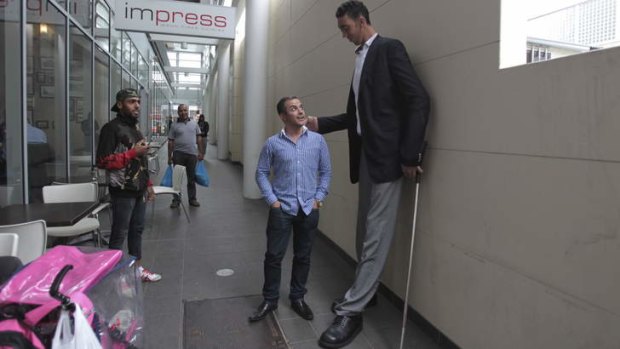 Sultan Kosen, the world's tallest man, meets Mikail Alkin, who is 169cm, in Auburn on Friday.