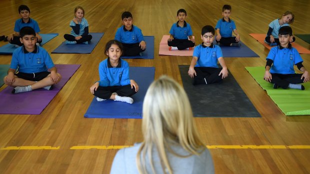 And ... exhale: Danielle Begg conducts a yoga class at Liverpool West Public School.