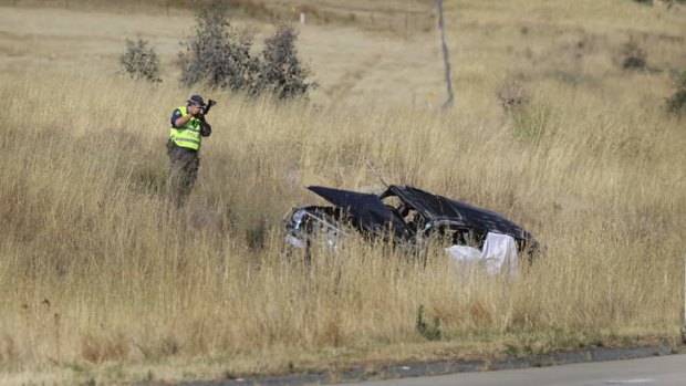An investigator takes photos at the scene of the fatal accident near Holbrook. Photo courtesy of David Thorpe, Border Mail.