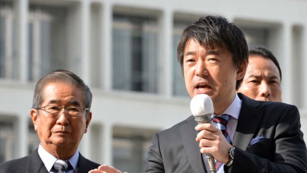 Osaka Mayor and Japan Restoration Party co-leader Toru Hashimoto delivering a speech for an election compaign while former Tokyo Governor and Japan Restoration Party co-leader Shintaro Ishihara looks on in November 2012.
