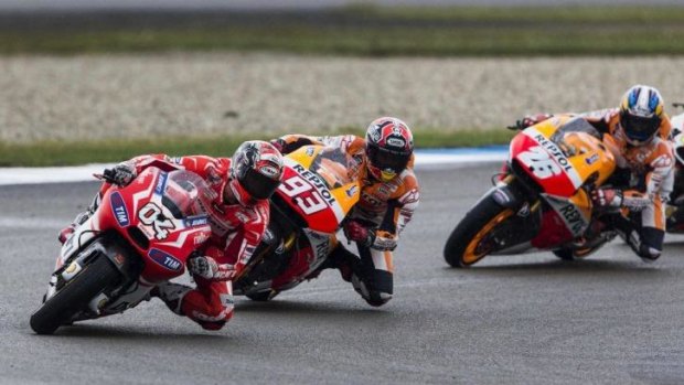 Marc Marquez (centre) of Spain, Andrea Dovizioso (left) of Italy and Dani Pedrosa of Spain take a curve during the Dutch Grand Prix.