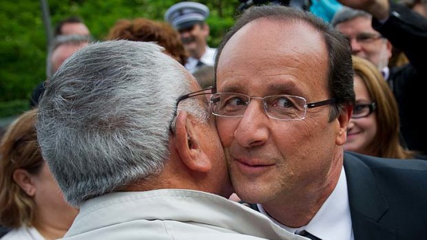 Common touch ... Francois Hollande hugs people at a ceremony to honour Nazi victims in Tulle on Saturday. The President is tipped to secure a parliamentary majority.