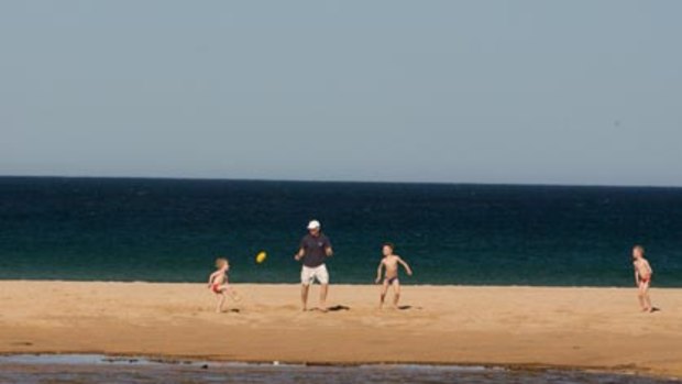 Making the most of the unusually high July temperatures ... Long Reef on Sydney's northern beaches turned it on for this family.