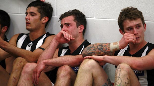 Bittersweet victory: Magpies Sharrod Wellingham, Jarryd Blair and Dayne Beams shed a tear for John McCarthy.