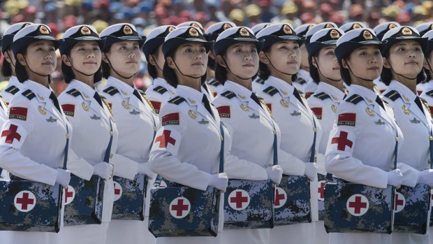Female Chinese soldiers of the medical corps ride in trucks during the military parade on Thursday last week: The holiday to commemorate the end of World War II couldn't have come at a better time for markets.