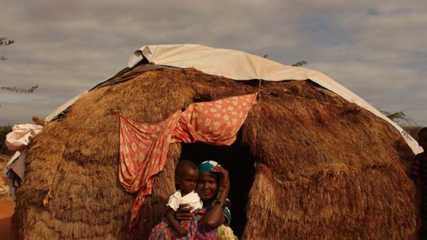 Respite ... mother of six Apshira Yusuf, who arrived from southern Somalia after a three-week walk, has built a shelter from grass and plastic.