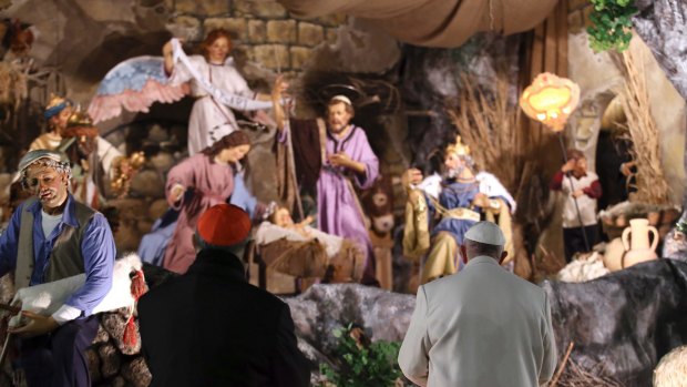 Pope Francis prays in front of the nativity scene after celebrating a new year's eve vespers Mass.