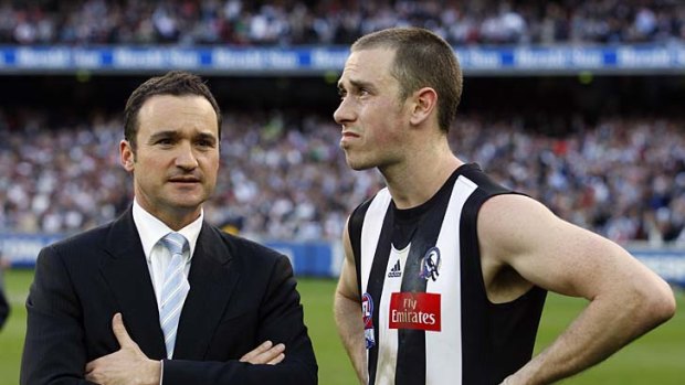 AFL Operations Manager Adrian Anderson talks to Magpies captain Nick Maxwell.