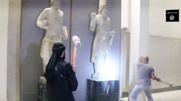 Militants attack ancient artefacts with sledgehammers.