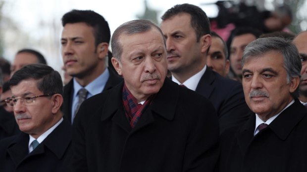 Turkish President Recep Tayyip Erdogan, centre, with former president Abdullah Gul, right, and former prime minister Ahmet Davutoglu, left. Opponents claim Mr Erdogan's crackdown on media and opposition is aimed at entrenching his ruling party, the AKP.