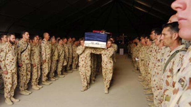 The casket of Corporal Mathew Hopkins is carried from his memorial service in Tarin Kowt.