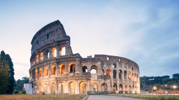 Landmark: The Colosseum in Rome at sunrise.