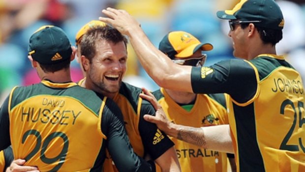 Teammates congratulate Dirk Nannes after taking the wicket of  Indian cricketer Yuvraj Singh.