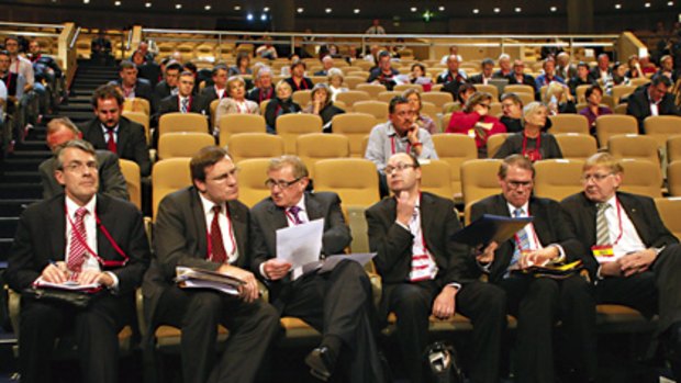 Stripped-down, pared-back, deliberately drab  ... Simon Crean, third from left, talks to the ALP national conference delegate Gerard Dwyer in Sydney yesterday.
