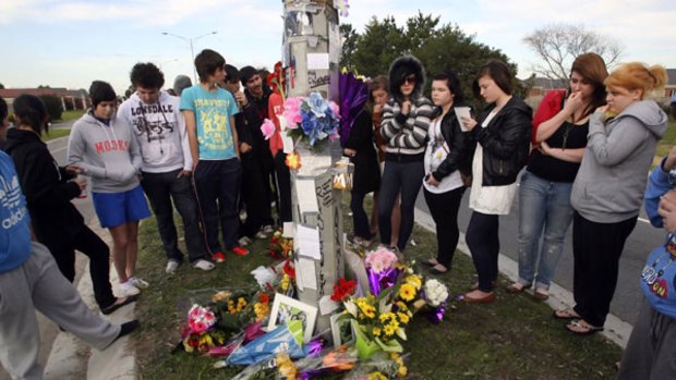 Floral tributes ... grieving teens visit the Lynbrook crash site where four teens died on June 28.