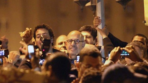 Outspoken ...Mohamed ElBaradei, centre, attends a demonstration in al-Tahrir square in Cairo.