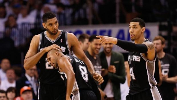 Tim Duncan gives Patrick Mills a congratulatory pat on the head on Sunday.