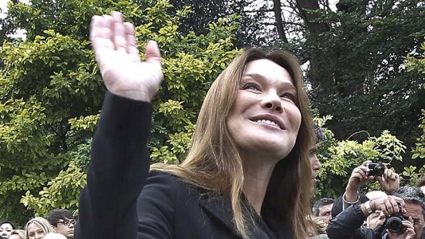 Baby joy ... a heavily-pregnant Carla Bruni-Sarkozy waves to the crowd in Paris last month.