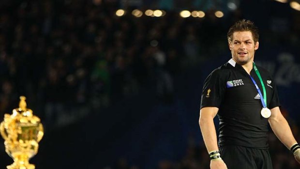 Job done ... All Blacks captain Richie McCaw gets ready to receive the Webb Ellis Trophy.