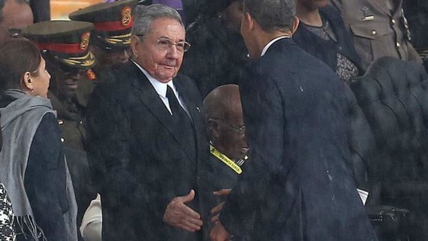 US President Barack Obama shakes hands with Cuban President Raul Castro.