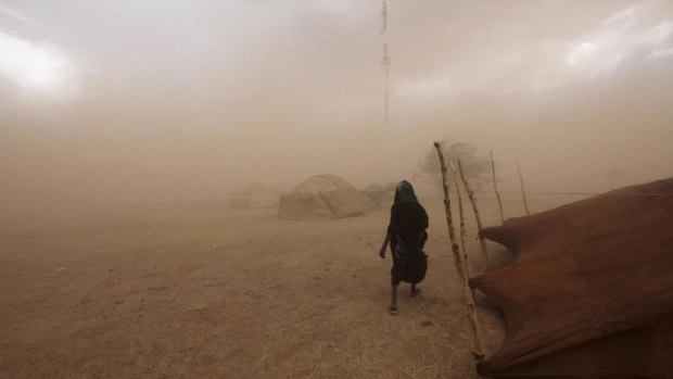 A Tuareg woman walks through a sandstorm in Niger.