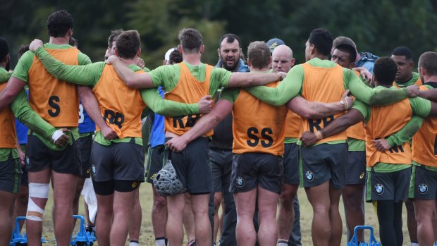 All lined up: Michael Cheika speaks to the Wallabies at training on Friday.